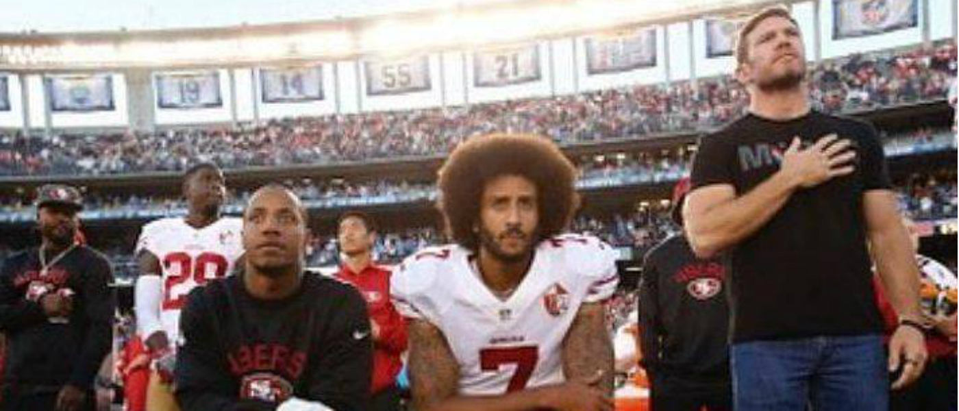 Colin Kaepernick kneels during National Anthem